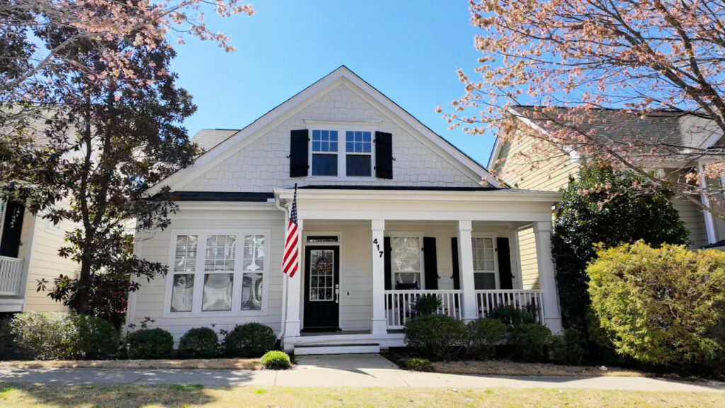 White home with American Flag in Sunset Oaks, Holly Springs, NC